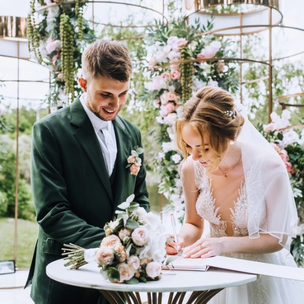 A,Stylish,Groom,In,A,Green,Suit,And,A,Bride